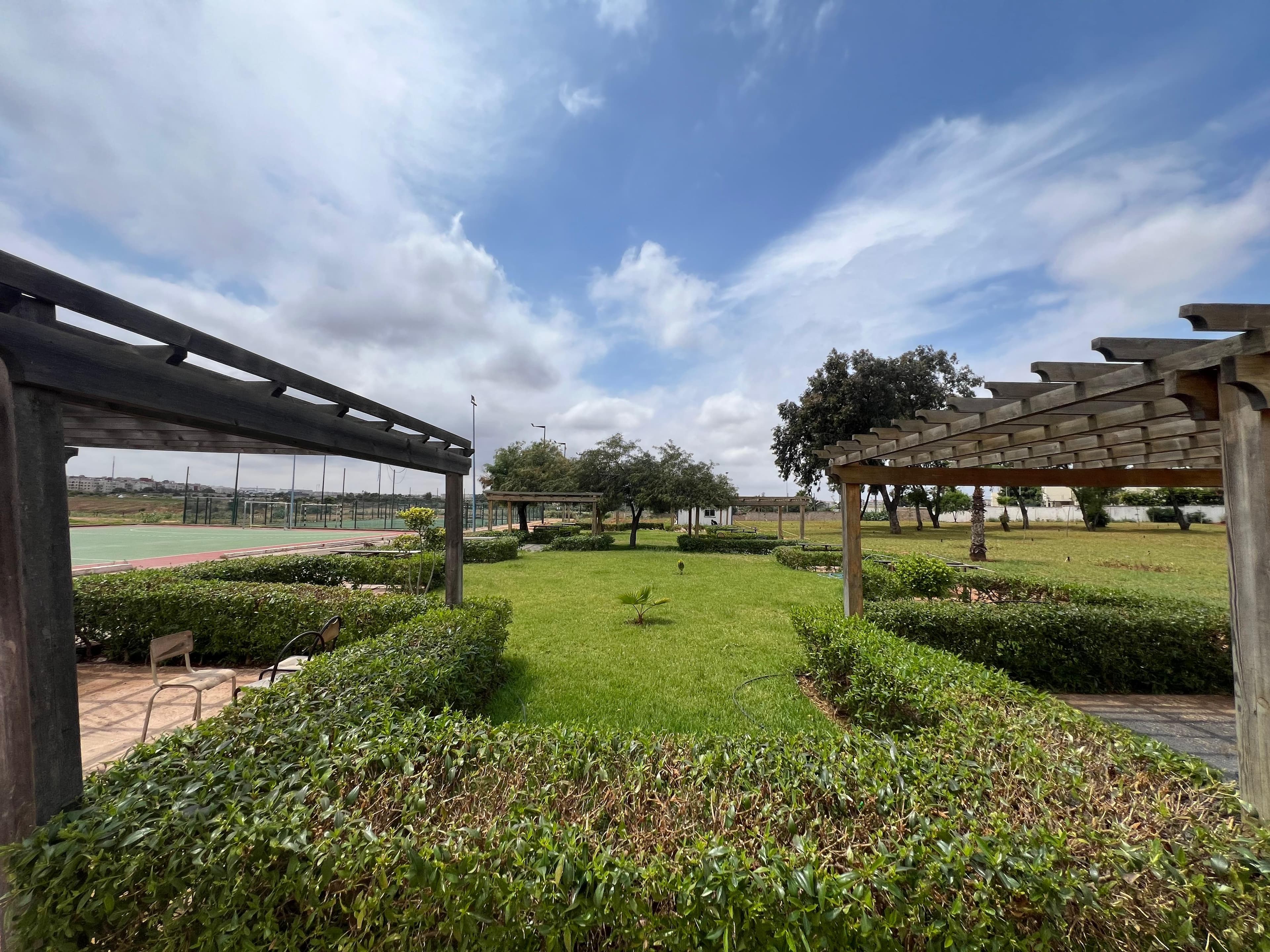Open green space with well-maintained grounds on the ENSEM campus.
