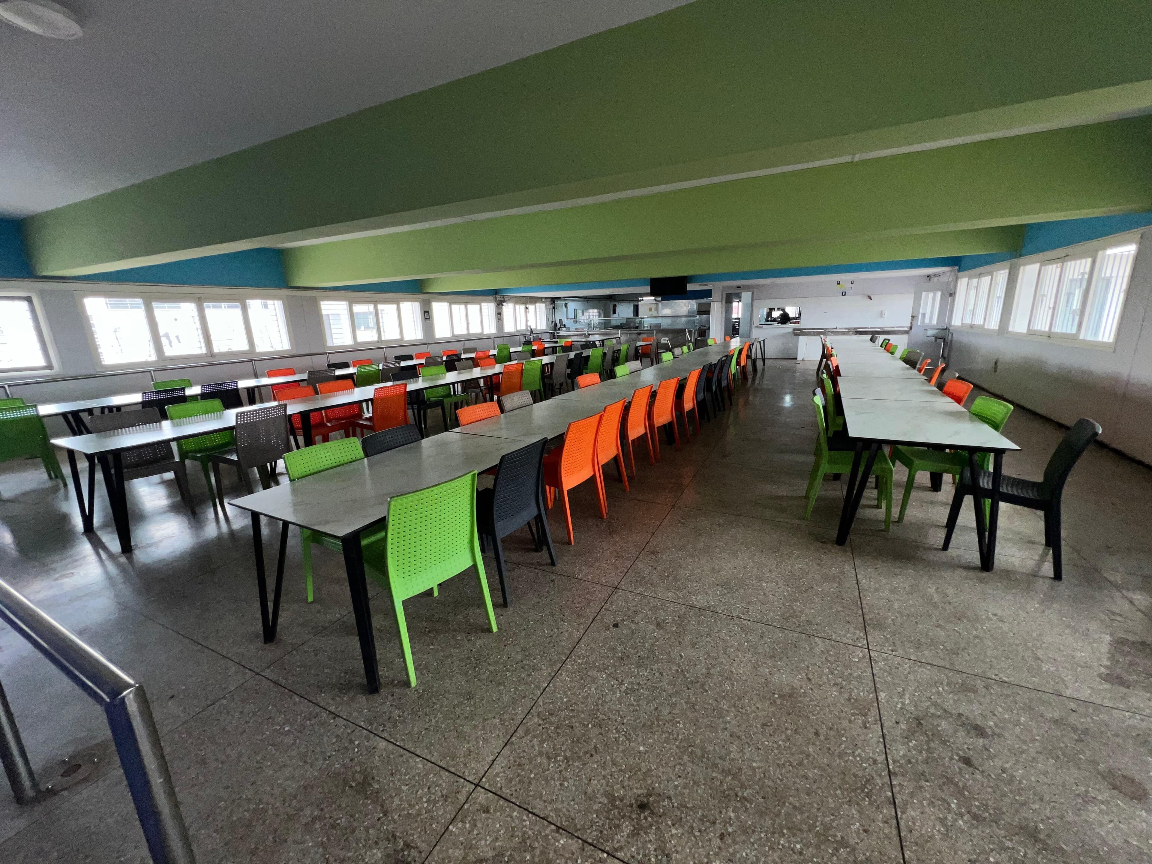 Interior of the ENSEM student restaurant with dining tables set for lunch.