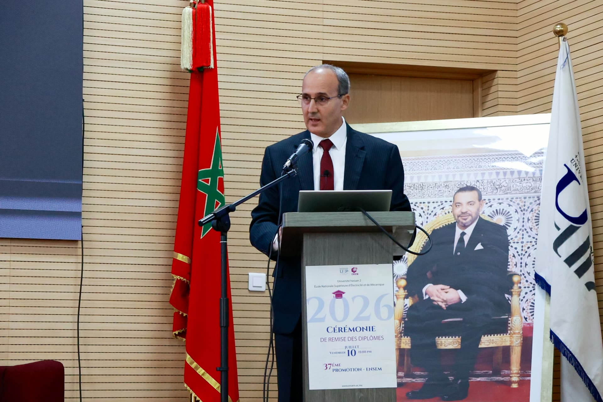 Pr. Ahmed Naddami, Director of ENSEM and coordinator of the UH2C Summer School 2026, speaking at the ceremony podium.