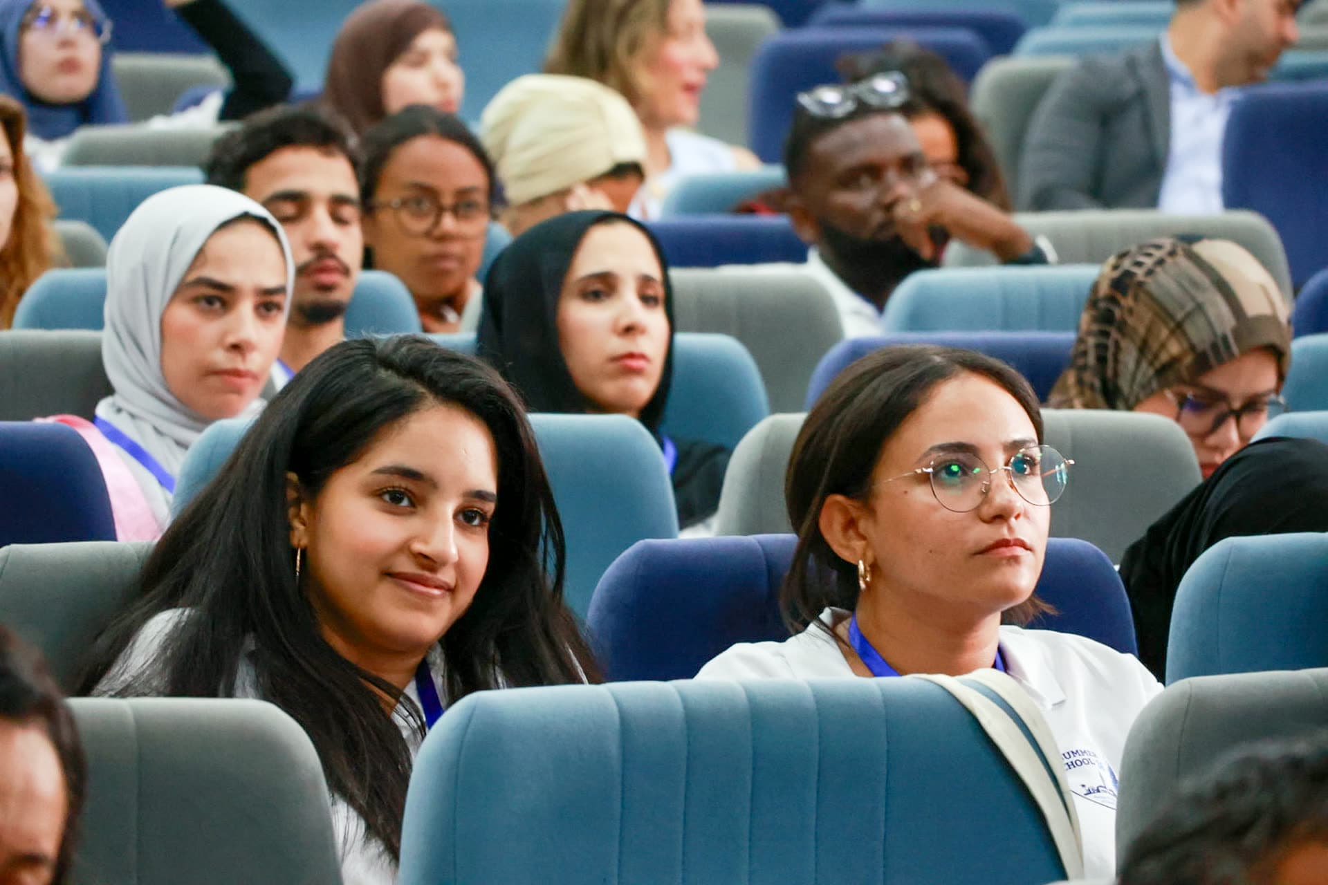 Close-up of engaged participants following a seminar in the auditorium.