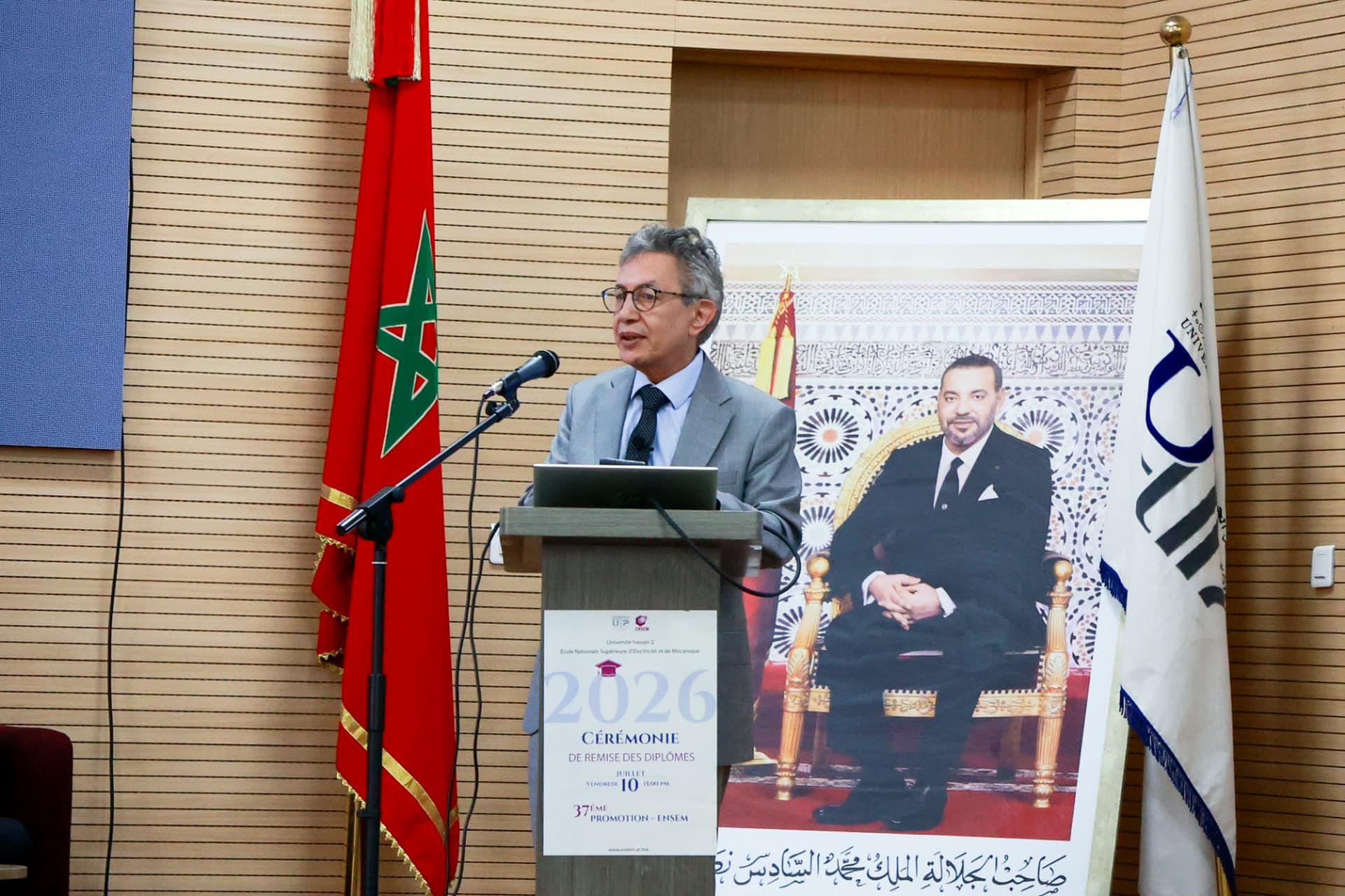 Pr. Houssine Azeddoug, President of Hassan II University of Casablanca, delivering the opening address at the podium.