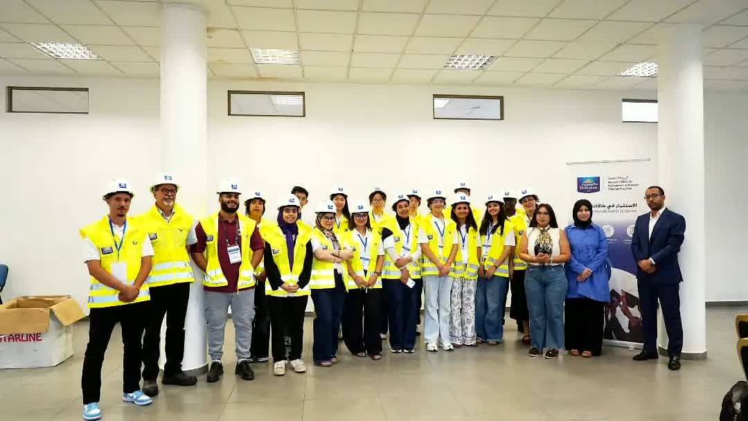 The cohort wearing helmets during the safety briefing before the Cosumar factory tour.