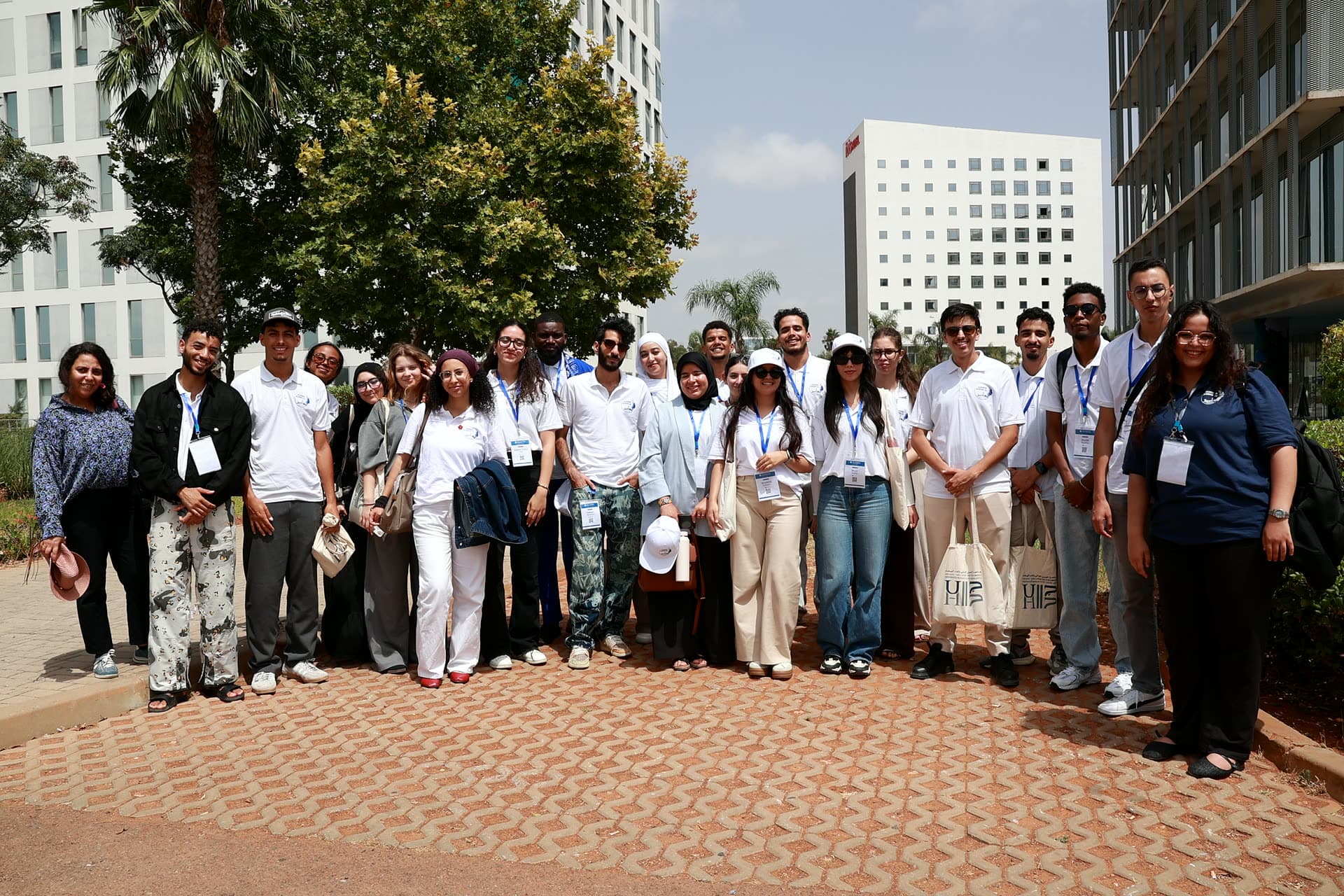 The cohort posing outdoors among the office towers at Leyton.