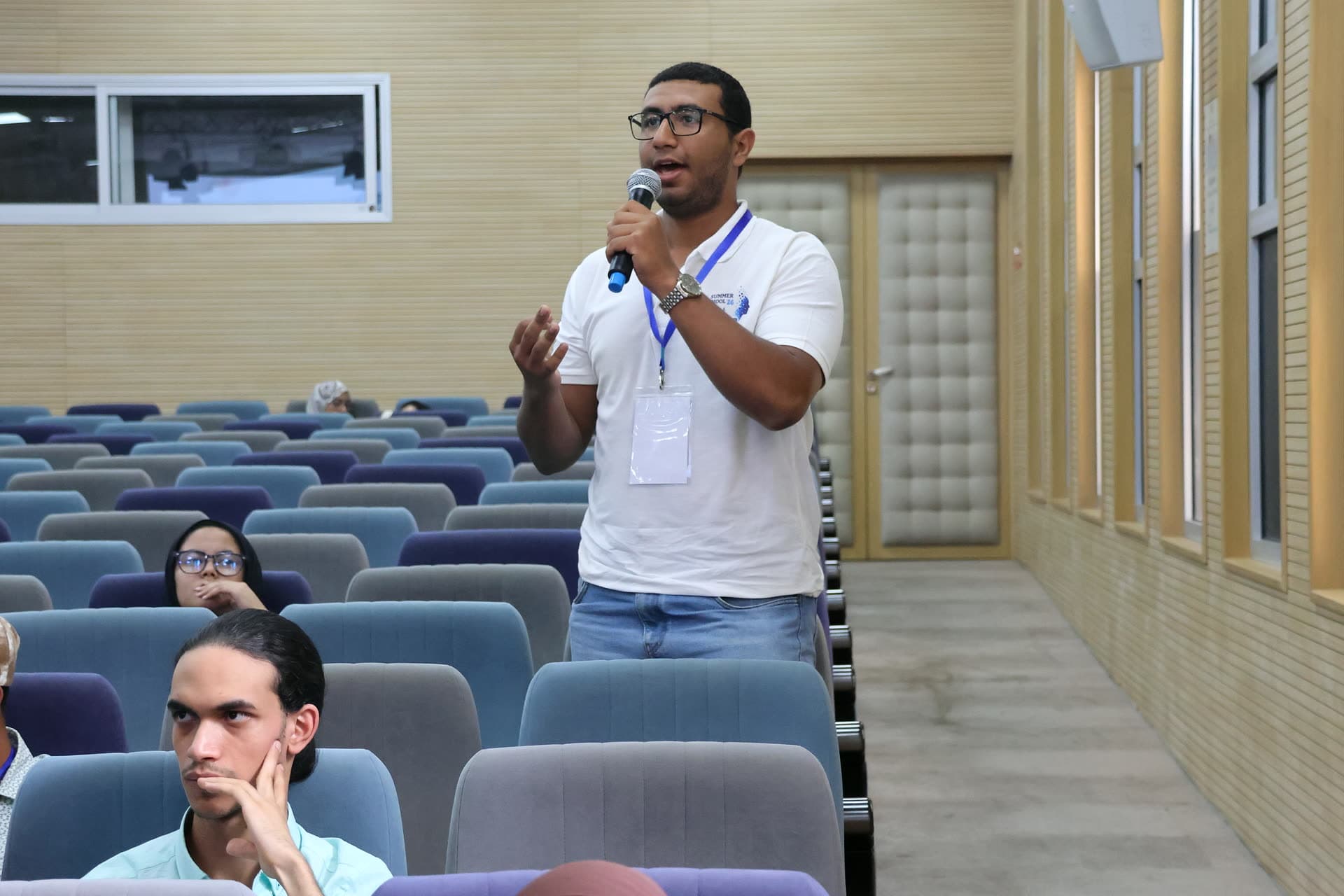 Participant asking his question from the aisle of the auditorium.