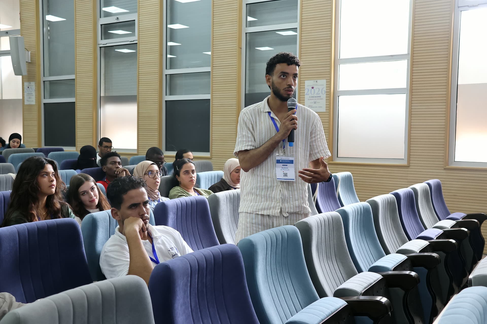 Participant standing among the rows to ask a question.