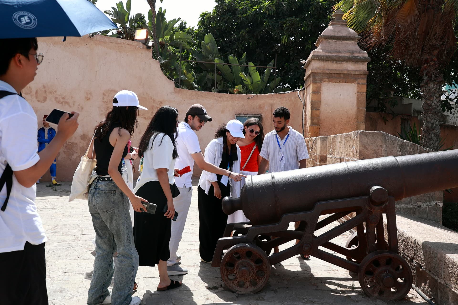 Participants examining a historic cannon on the sqala rampart.