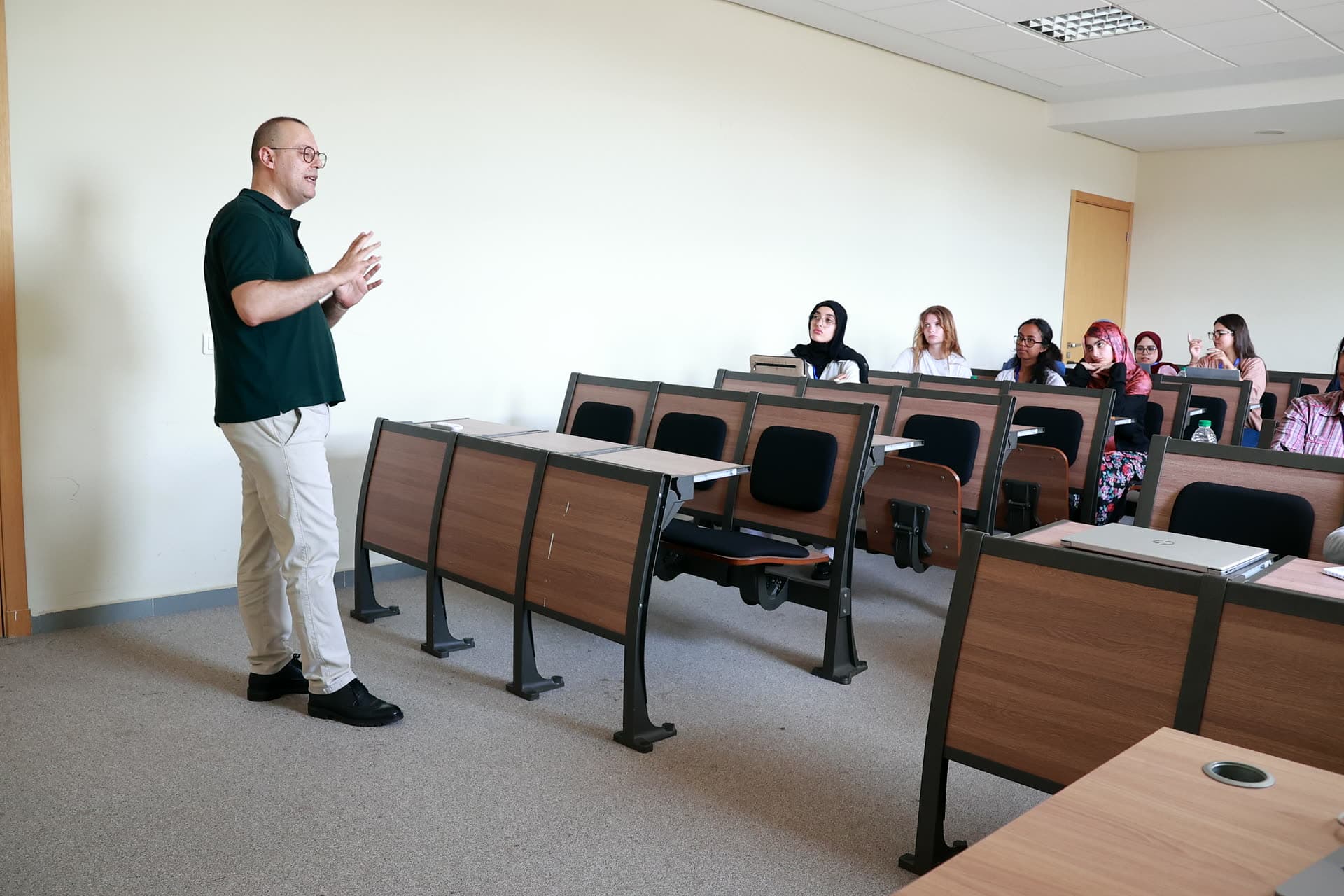 Instructor presenting to participants in a tiered classroom.
