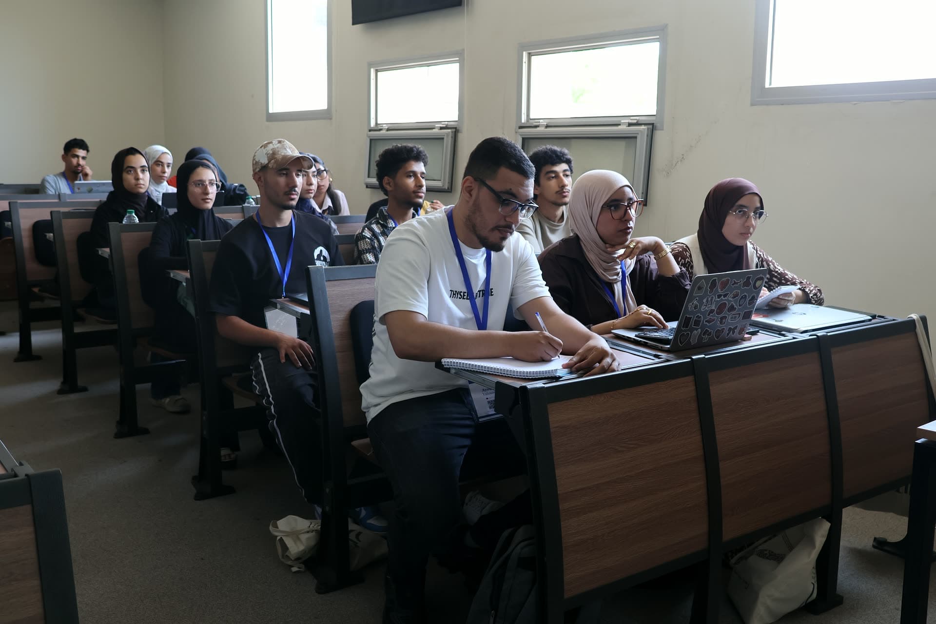 Participants in the workshop classroom following the exercise on their laptops.