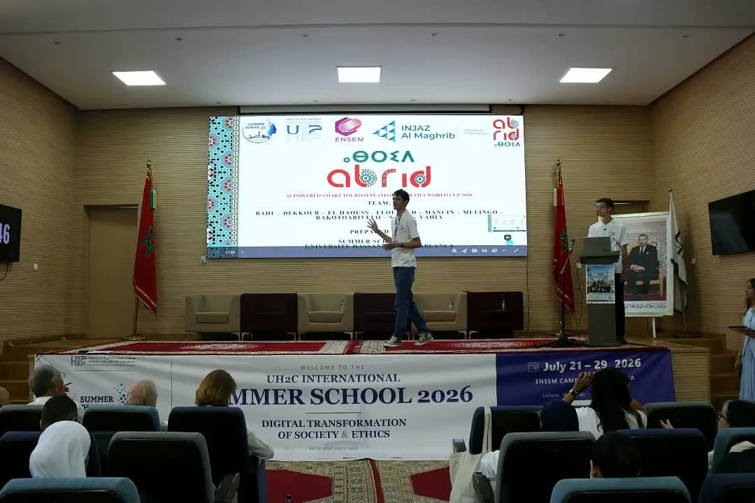 Participant pitching team Abrid beneath the partner screen.