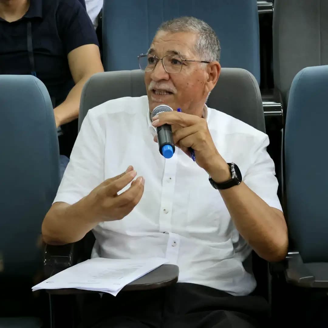 Senior jury member giving feedback at the microphone.