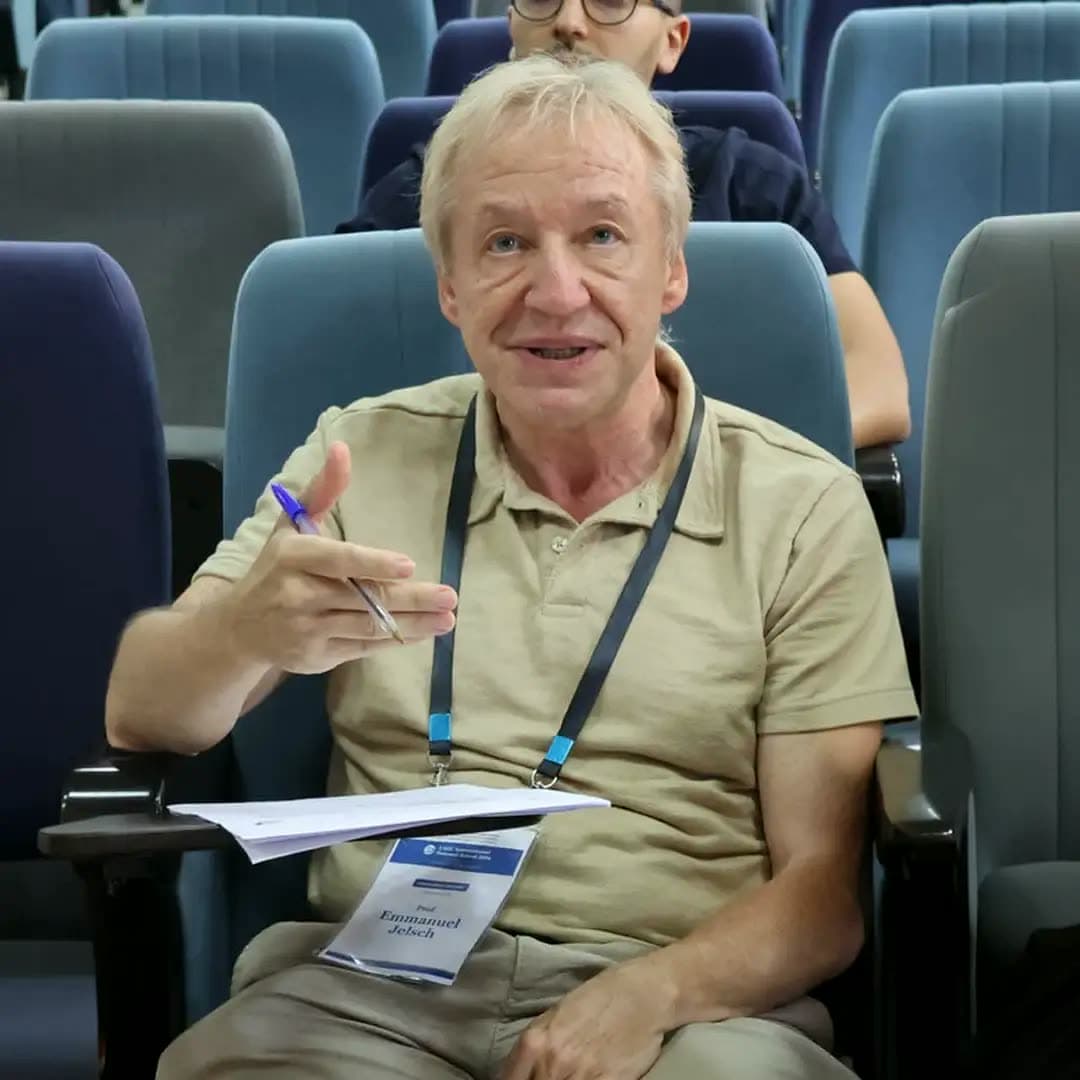 Jury member reacting with a pen in hand during a pitch.
