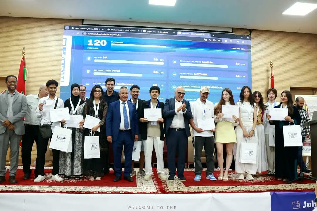 Teams with certificates in front of the results screen.