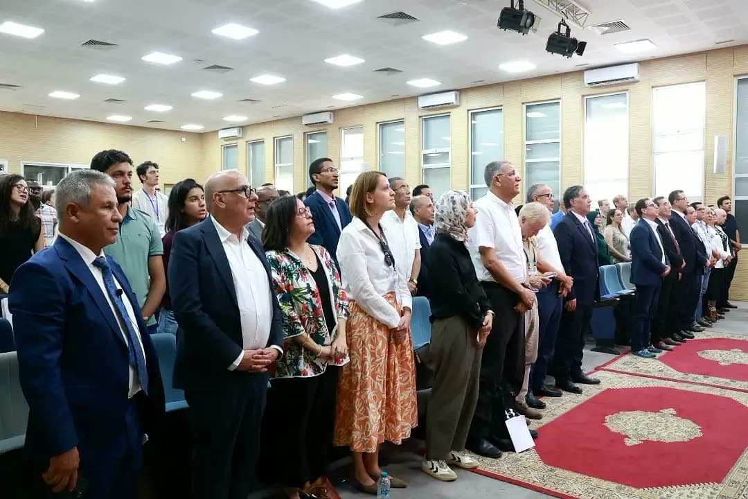 Officials and guests standing at the opening of the ceremony.