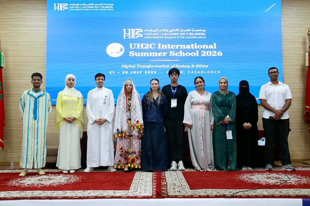 Team FinGo on stage in traditional dress at the closing ceremony.