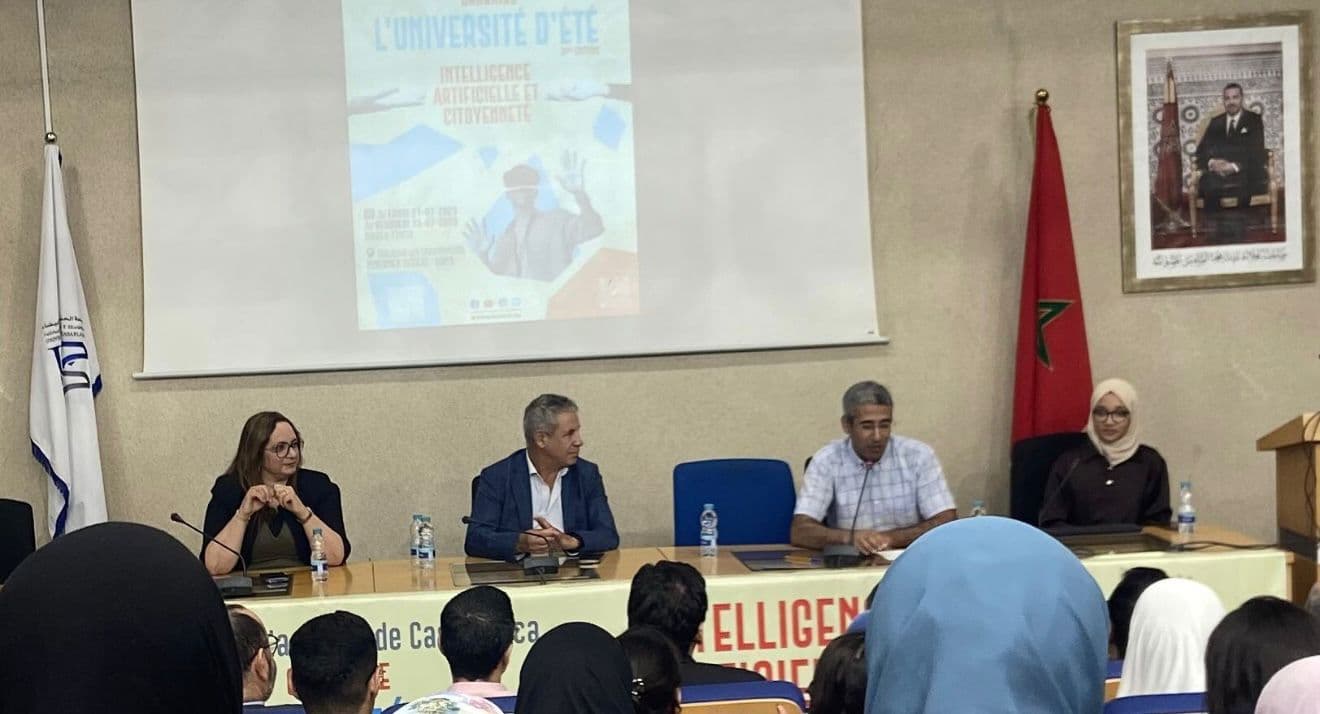 Opening panel of the 3rd edition with four speakers in front of the AI & Citizenship poster.