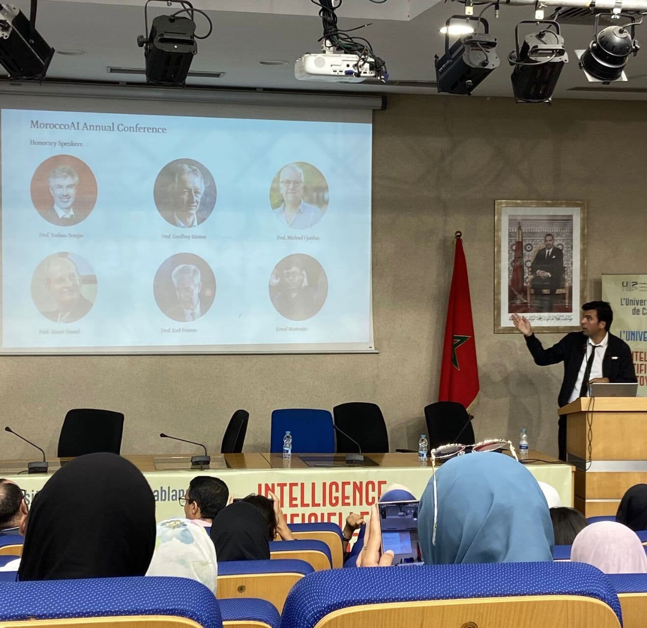 Speaker presenting the MoroccoAI Annual Conference honorary speakers, including Bengio, Hinton and LeCun.